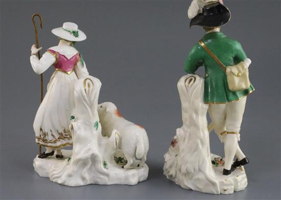 A pair of Rockingham porcelain groups of a shepherd and shepherdess, c.1830, h. 21.5 and 18cm, some faults